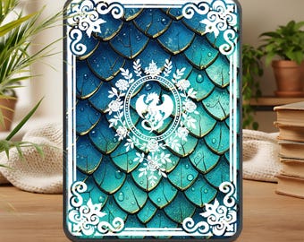 May include: A rectangular tablet case featuring a teal and gold dragon scale pattern. A white dragon emblem is centered within a floral wreath. The case has a white border with decorative flourishes.