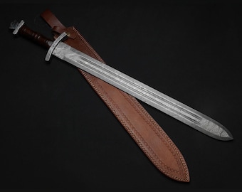 May include: A long, silver sword with a patterned blade rests in a brown leather sheath. The sword has a dark brown handle and a silver crossguard. The sheath is also brown and has decorative stitching along the edges. The sword and sheath are set against a black background.