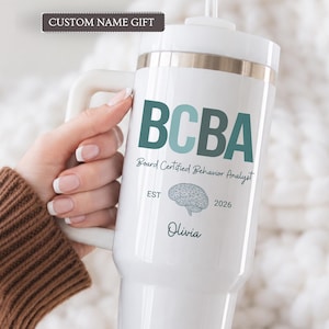 May include: A white insulated tumbler with a handle and straw, featuring the teal text BCBA, the words Board Certified Behavior Analyst, a brain illustration, the text EST 2026, and the name Olivia printed in a dark teal script font.