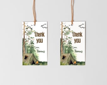 May include: Two printable thank you tags with a camping theme. The tags feature a watercolor illustration of a green tent, a campfire, and trees. The text on the tags reads "thank you" and "Love, Thomas".