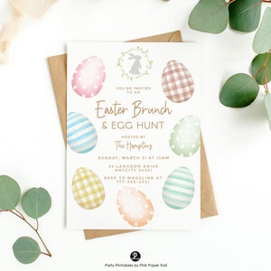 May include: An Easter Brunch & Egg Hunt invitation with watercolor egg designs in pastel colors. The invitation includes the text "You're Invited to an Easter Brunch & Egg Hunt" and event details. A brown envelope is behind the invitation.
