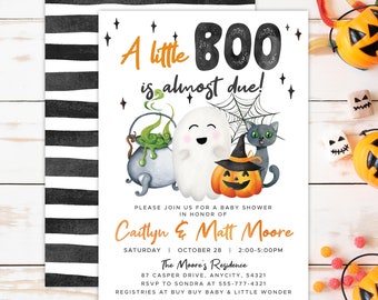 May include: Halloween-themed baby shower invitation with the text "A little BOO is almost due!" featuring a ghost, pumpkin, black cat, and cauldron. The invitation includes event details and a black and white striped back design.