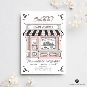 May include: A pink and black illustrated invitation card for a birthday party. The card features a cafe with the text "Ooh la la!" and "Cafe Amelia." The invitation includes the date, time, and location of the party.