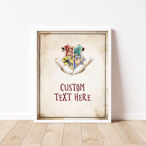 May include: A printable poster featuring the Hogwarts crest with the words "CUSTOM TEXT HERE" below it. The crest is a shield with a lion, eagle, badger, and snake in the four quadrants. The shield is surrounded by a banner with the words "Draco Dormiens Nunquam Titillandus" in Latin.
