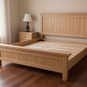 Op de afbeelding: Een lichtgekleurd houten bedframe met een hoofdbord en voetbord. Het bedframe is gemaakt van verticale houten planken en heeft een lattenbodem. Het bedframe is ongeveer 203 cm lang.