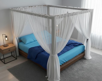 May include: A four-poster bed with a wooden frame, draped with white sheer curtains. The bed is made with a light blue sheet, a dark blue comforter, and a matching pillow. A small wooden nightstand with a lamp sits beside the bed.