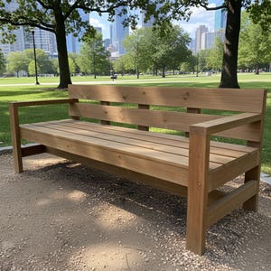 May include: A wooden park bench with a backrest and armrests. The bench is made of light brown wood and is positioned on a gravel path in a park setting. The bench is approximately 6 feet long.