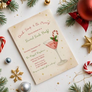 May include: A festive invitation for a Secret Santa party, featuring a cocktail illustration with a candy cane garnish. The invitation is surrounded by Christmas ornaments, candy canes, and evergreen branches, creating a holiday theme.