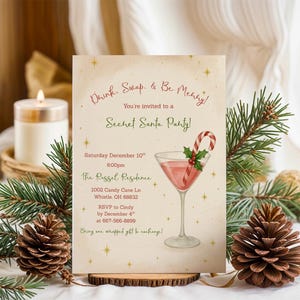 May include: A festive invitation for a Secret Santa party. The card features a watercolor illustration of a pink cocktail with a candy cane and holly. Text includes "Drink, Swap, & Be Merry!" and party details.