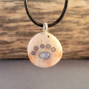 Sunstone Pendant Inlaid with Silver Bear Paw Print and Blue Fluorite Gemstone.