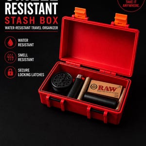 May include: A red, rectangular, water-resistant stash box with orange locking latches. The open interior contains a black circular grinder, a black lighter, a black cylindrical tube, and a pack of RAW natural unrefined rolling papers.