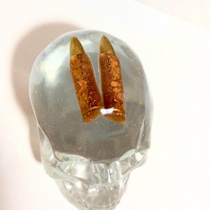 Clear, resin skull with holographic gold bullets