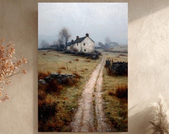 May include: A framed landscape painting depicts a rural scene with a white cottage, a dirt road, and stone walls. The artwork is displayed above a beige floor cushion with an orange pillow and a gray throw blanket. A large vase with dried plants is on the left.