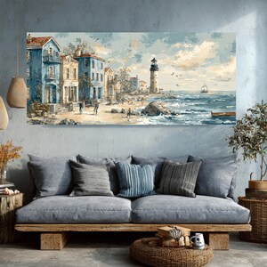 May include: A coastal landscape painting featuring buildings in shades of blue and beige, a lighthouse, and a beach with figures. The artwork depicts a serene seaside scene with a sailboat on the horizon and a cloudy sky.