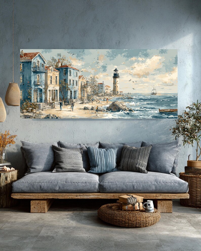 May include: A coastal landscape painting featuring buildings in shades of blue and beige, a lighthouse, and a beach with figures. The artwork depicts a serene seaside scene with a sailboat on the horizon and a cloudy sky.