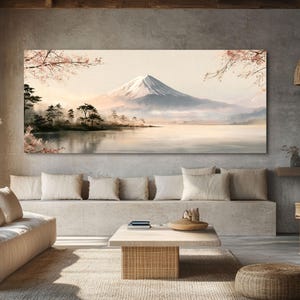 May include: A rectangular wall art print featuring a landscape of a snow-capped mountain rising above a calm lake. The scene includes soft pink cherry blossom branches in the foreground and dark green pine trees along the shoreline.