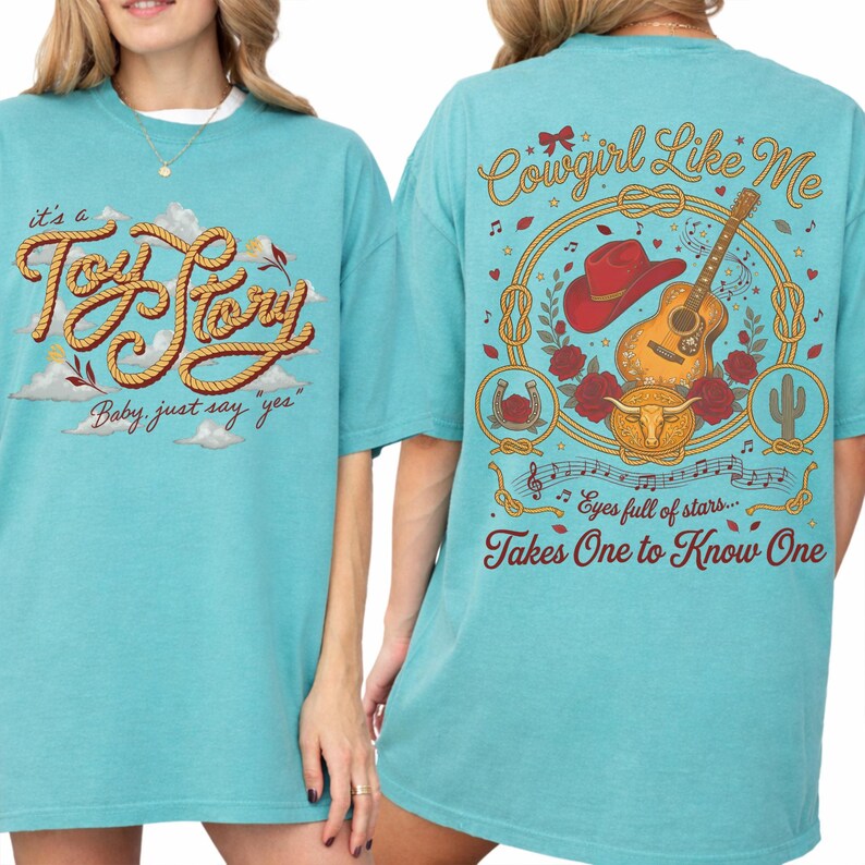 May include: A turquoise t-shirt featuring a front graphic with the text "it's a Toy Story Baby, just say yes" in rope-style lettering. The back graphic displays "Cowgirl Like Me" and "Takes One to Know One" with a guitar, red hat, and roses.