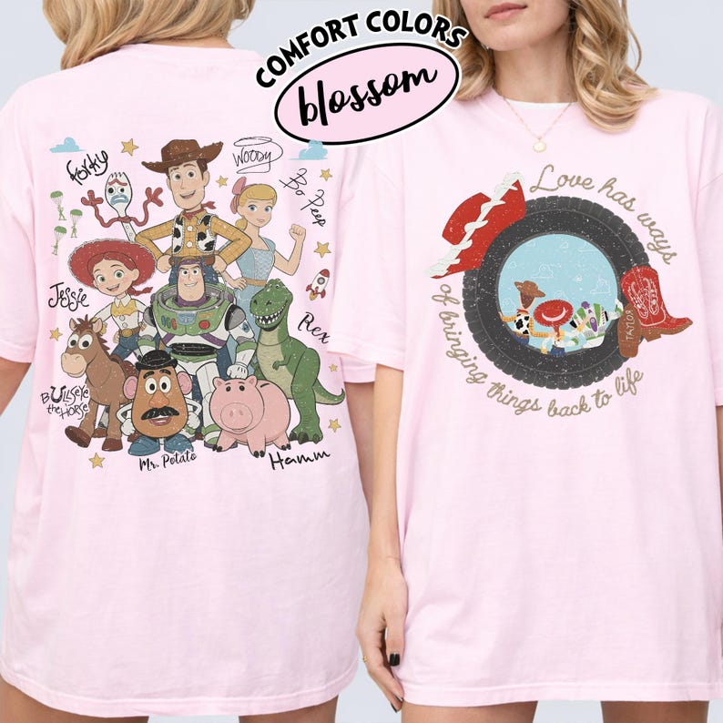 May include: A light pink t-shirt featuring Toy Story characters on the back, including Woody, Buzz Lightyear, Jessie, Bullseye, Mr. Potato Head, Rex, Hamm, Bo Peep, and Forky. The front displays a tire graphic with cowboy boots and the text Love has ways of bringing things back to life.