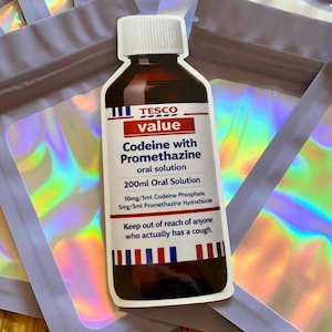 May include: A sticker of a Tesco Value Codeine with Promethazine oral solution bottle. The label reads "200ml Oral Solution" and "Keep out of reach of anyone who actually has a cough." The sticker is surrounded by iridescent pouches.