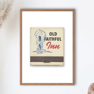 May include: A framed print featuring a vintage matchbook design. The matchbook has a cream-colored background with a blue and white illustration of a geyser and the words "OLD FAITHFUL Inn" in red and black. The frame is a light brown color.