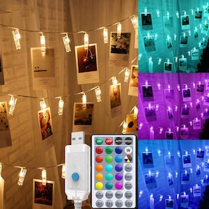 May include: A string of LED fairy lights with integrated clear clips for displaying photographs. The set includes a USB power connector and a multi-button remote control for adjusting colors, brightness, and lighting modes like fade and flash.
