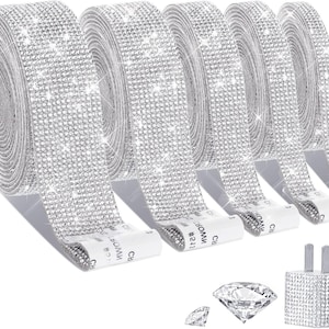 May include: Five rolls of silver-toned adhesive ribbon covered in small, reflective faux rhinestones. Each roll features a white backing strip with the text CROWN #541. Also included are two loose, clear, faceted diamond-shaped decorative accents.