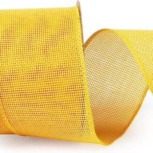 May include: A roll of bright yellow ribbon featuring a wide, open-weave mesh texture. The ribbon is wound around a central core and extends outward in a loose, flowing curve, showcasing the consistent grid pattern of the fabric material.