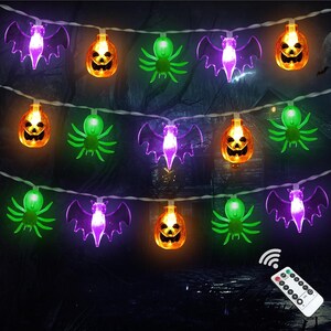 May include: A string of Halloween LED lights featuring purple bats, orange jack-o'-lanterns, and green spiders. The lights are connected by a white wire and include a white remote control with multiple buttons for adjusting the light settings.