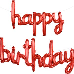 May include: Red foil balloons spelling out "happy birthday" are suspended against a white background. The balloons are in a cursive font and are connected by a thin string. The image is a festive decoration for a birthday celebration.
