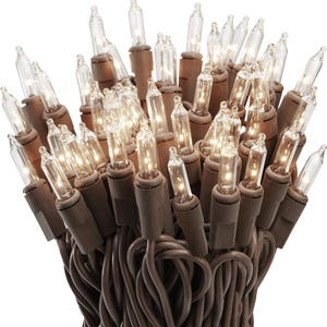 May include: A bundle of string lights featuring numerous small, clear incandescent bulbs attached to a brown wire. The lights are arranged in a dense, upright cluster, with each bulb seated in a brown plastic base, creating a warm glow.