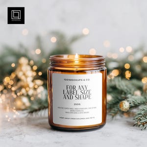 May include: A lit scented candle in a brown glass jar with a white label. The label reads "FOR ANY LABEL SIZE AND SHAPE" and "250g". The candle is surrounded by festive greenery and bokeh lights. The text "1001 MOCKUPS & CO." is also visible.