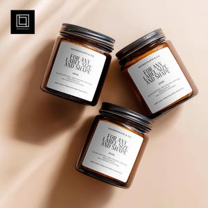 May include: Three brown glass jars with black lids, each with a white label that reads "FOR ANY LABEL SIZE AND SHAPE" and "250g". The jars are arranged on a light brown surface. The logo "1001 MOCKUPS & CO" is visible.