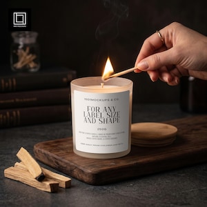 May include: A frosted glass candle in a clear jar with a white label reading 1001MOCKUPS & CO. FOR ANY LABEL SIZE AND SHAPE 250G. The candle has a lit wick with visible smoke. A wooden lid sits nearby, and a match is held near the flame.