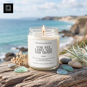 May include: A lit scented candle in a clear glass jar with a white label reading 1001MOCKUPS & CO. FOR ANY LABEL SIZE AND SHAPE 250G. The label lists non-toxic ingredients including soy wax, essential oils, and coffee beans. The candle is 250 grams.