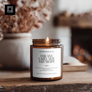 May include: A lit, brown glass jar candle with a white label that reads "FOR ANY LABEL SIZE AND SHAPE". The candle is labeled "1001MOCKUPS & CO." and "250g". The candle is on a wooden surface.