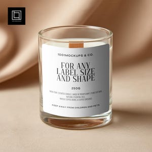May include: A clear glass candle jar with a white label that reads "FOR ANY LABEL SIZE AND SHAPE". The candle is filled with wax and has a wooden wick. The label also states the candle is 250g and made with natural essential oils.
