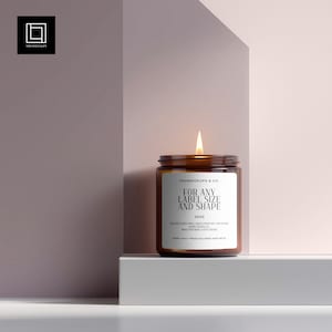 以下が含まれることがあります： 「FOR ANY LABEL SIZE AND SHAPE」と書かれた白いラベルが付いた、点灯した琥珀色のガラスのキャンドルジャー。 キャンドルは、2色のピンクとグレーの背景に対して、白いプラットフォームにあります。 キャンドルの重さは250gです。