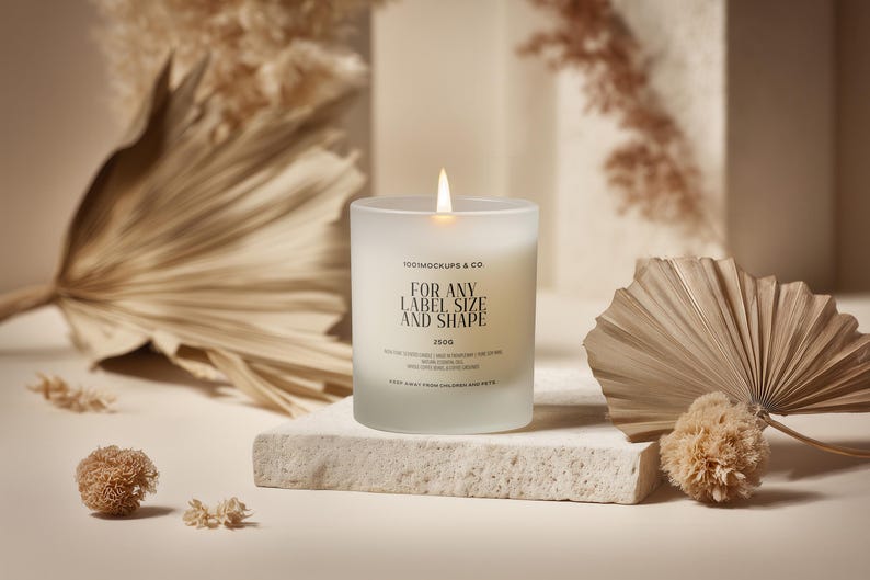 May include: A lit, frosted glass candle with the text "FOR ANY LABEL SIZE AND SHAPE" is centered on a stone block. Dried plants and decorative elements surround the candle, creating a neutral, earthy aesthetic. The candle is labeled "150g".