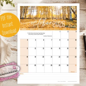 May include: A printable October 2026 calendar page featuring a photograph of an autumn forest with golden trees. The calendar includes a grid with dates, a quote by an unknown author, and a notes section at the bottom. The text reads October 2026.