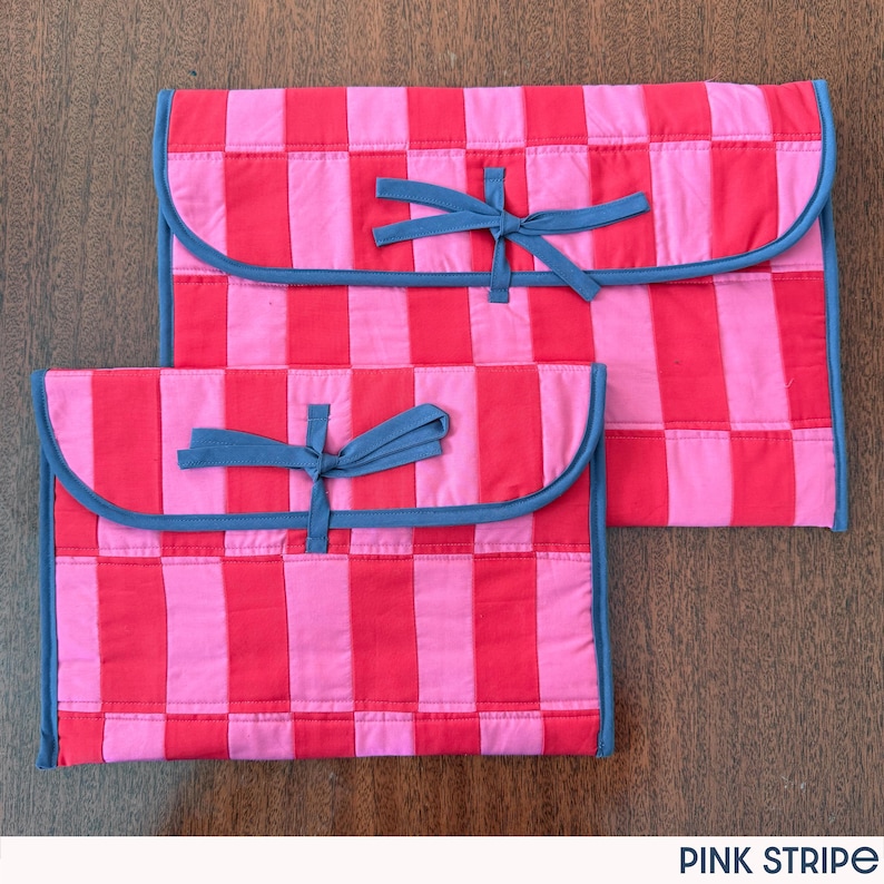 May include: Two pink and red striped fabric pouches with blue trim and ties. The pouches are different sizes and have a quilted appearance. The text "PINK STRIPE" is at the bottom of the image.