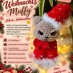 May include: A crocheted gray bear toy wearing a red Santa hat and red sweater with white embroidered snowflakes. The bear has a grumpy expression with large dark eyes. Text on the image includes "Weihnachts-Muffy" and "Och nö... Weihnachten."