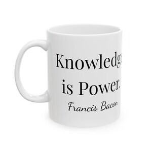 May include: White ceramic mug with the quote "Knowledge is Power" and the name "Francis Bacon" printed in black. The mug has a curved handle and a glossy finish, suitable for hot or cold beverages.
