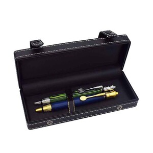 May include: Black leather pen case with white stitching, holding three pens. The pens are green, blue, and silver with gold accents. The case has a clasp closure and a strap to secure the pens.