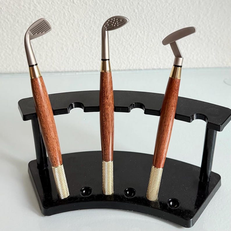 Mahogany Golf Pen Set — three pens shaped as driver, putter, and iron with felt-lined display box that doubles as a desktop putting green