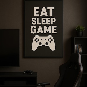 May include: Black framed poster with the words "EAT SLEEP GAME" in large white letters, with a white game controller graphic below. The poster hangs on a dark wall above a black gaming chair.