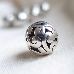 10 Silver scroll pattern with Black Antiquing beads, 11mm x 11mm, hole diameter 2mm, package of 10