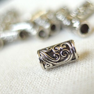 25 silver tone plated metal scroll pattern tube beads, 9mm long x 4mm wide, 3mm hole, pkg 25