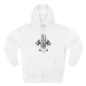 May include: A white hooded sweatshirt featuring a black and white graphic print on the chest. The design depicts a skeletal rib cage with bat wings, a skull wearing a crown, and two roses positioned at the base of the illustration.