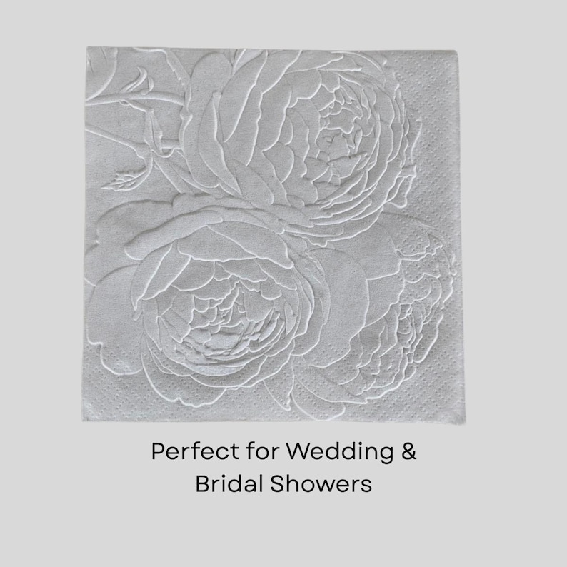 Puede incluir: Servilleta de papel cuadrada gris claro con un dise&ntilde;o floral en relieve con tres grandes flores de peon&iacute;a. El texto "Perfect for Wedding & Bridal Showers" est&aacute; impreso en la parte inferior de la servilleta.