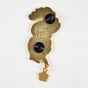 May include: Gold-coloured metal pin featuring a cartoon-style seahorse with a star-shaped charm. The pin has two black butterfly clasps on the back and the text "Loaf Parrot" is printed on the back.